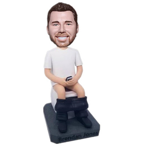 Joking Bobblehead Man Sitting on The Toilet with Phone in Hands